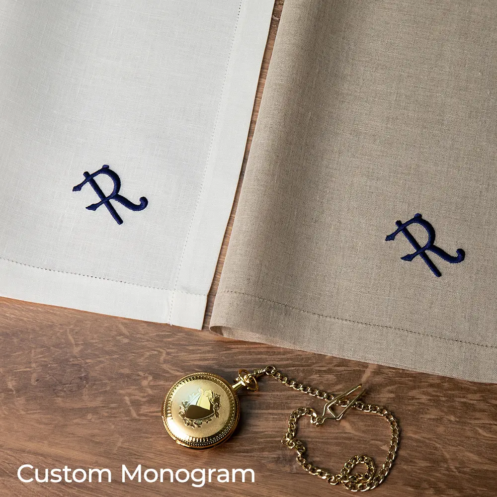 The white and natural Thomas Ferguson Irish Linen Handkerchiefs with a custom monogram embroidered on each one.
