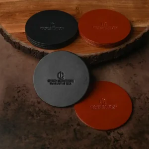 Set of four 4in round Chosen Leatherwork Stamped English Bridle Leather coasters in black and brown, each stamped with a circular logo and text.